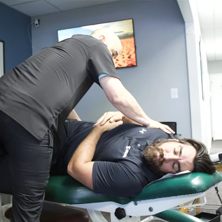 Chiropractor Escondido CA Jason Kart Adjusting Patient Neurologically Based Chiropractic Services